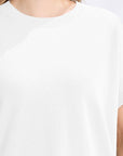 White t-shirt worn by a person on a white background