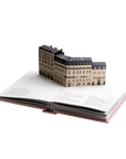 Model of a building on top of an open book
