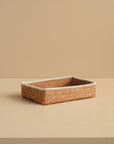 Woven rectangular basket on a beige background