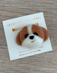 Felted dog head pin on a card with 'Jackelope Treasures' branding on a wooden surface.
