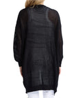 Person wearing a black mesh dress with a white background