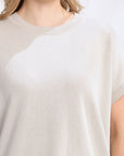 White t-shirt worn by a person on a white background