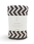 A rolled-up gray and off-white chevron-patterned cotton towel with a white paper label band in the center. The label reads 'ecovask' and 'hair & travel towel'.