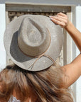 Woman wearing a straw hat with a white background