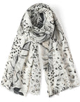 White scarf with black animal print pattern on a white background