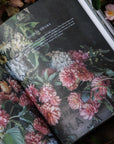 Floral book open on a bed of flowers and leaves