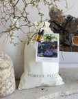 Bag labeled 'Forest Floor' with decorative elements on a neutral background
