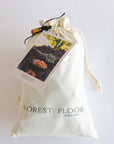 White drawstring bag with 'Forest Floor' branding on a white background