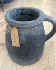 Cement mug with a tag on a wooden floor