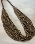 Multistrand beaded necklace on a light wooden surface