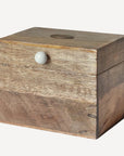 Wooden box with a white knob on a white background