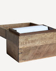 Wooden tissue box with a white tissue on a white background