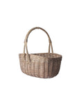 Wicker basket with handles on a light gray background