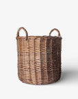 Wicker laundry basket with handles on a white background