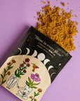 Star dust sugar scrub packaging with yellow powder on a purple background