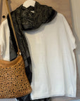 Handbag with a leopard print pattern on a wooden surface