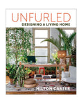 Book cover of 'Unfurled: Designing a Living Home' by Hilton Carter with a modern living room design.