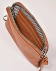 Brown leather pouch with zipper on a light gray background
