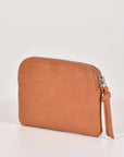 Brown leather wallet with a zipper on a light beige background