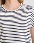 Person wearing a black and white striped t-shirt on a plain background