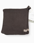 Brown knitted pouch with a brand tag on a white background