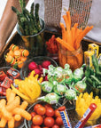 Assorted snacks including candy, vegetables, and chips on a tray.