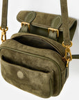 An olive green crossbody bag made of suede and leather, featuring gold-tone hardware, a front zippered pocket, and a top flap with buckle details, shown against a plain white background.