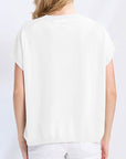 Person wearing a white t-shirt and pants on a plain background