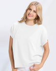 Woman wearing a white t-shirt and pants on a white background