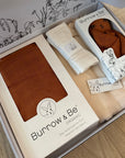 Box containing Burov & Be products on a wooden surface