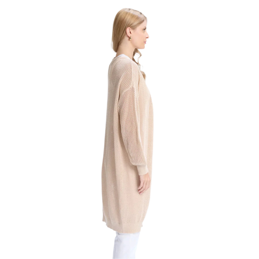 Woman wearing a beige cardigan and white pants on a white background