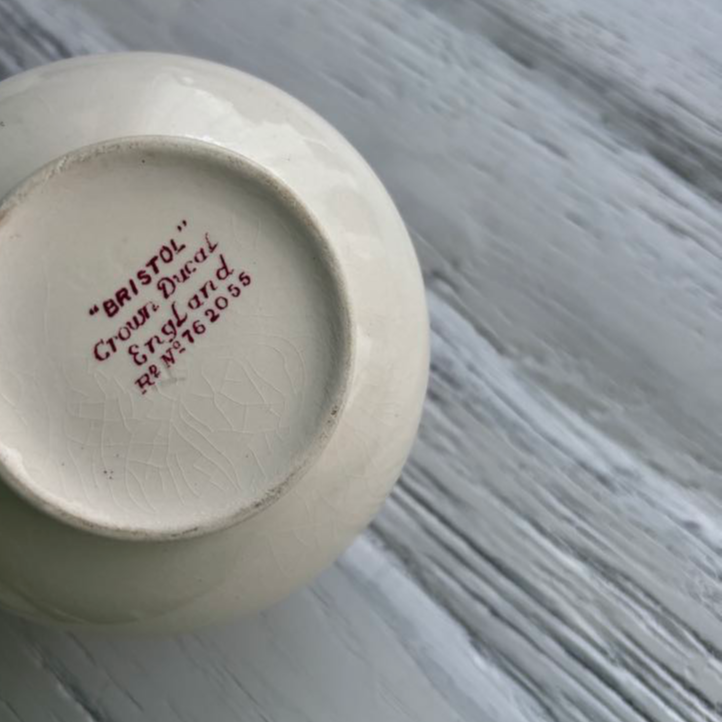 White ceramic jug with 'Bristol' branding on a white gray surface