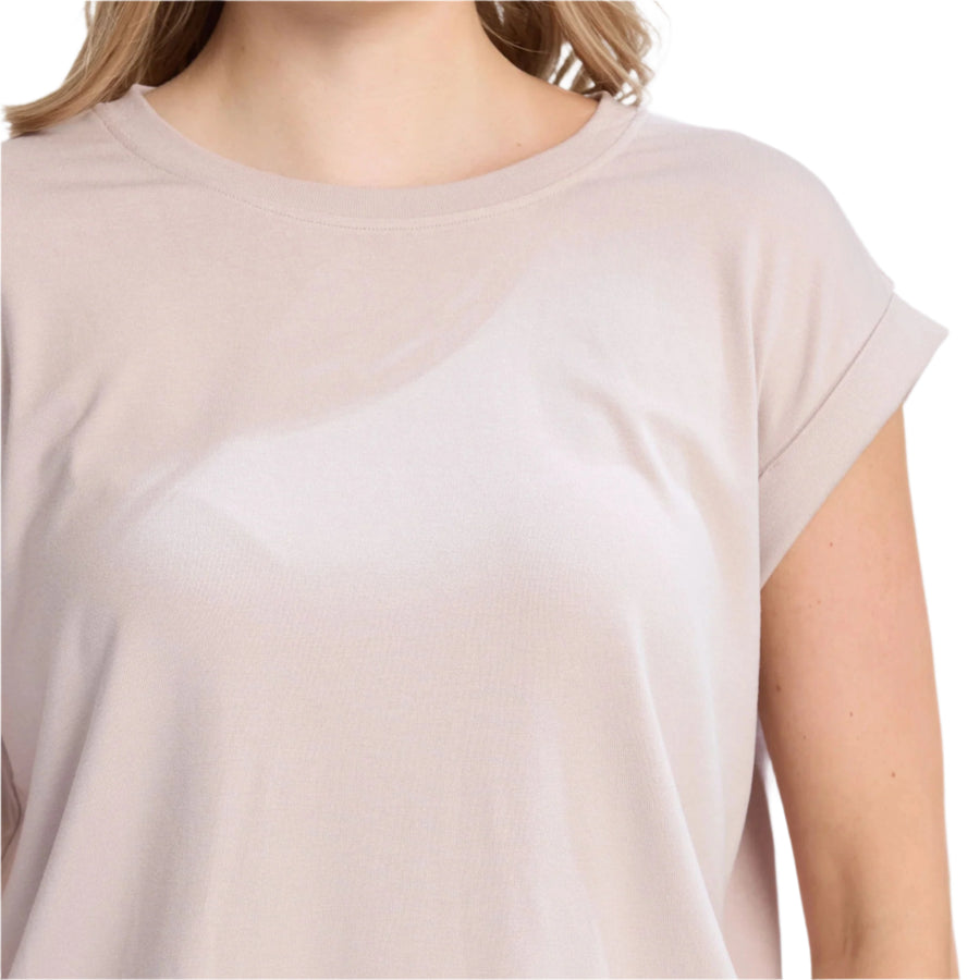 Beige t-shirt worn by a person on a white background