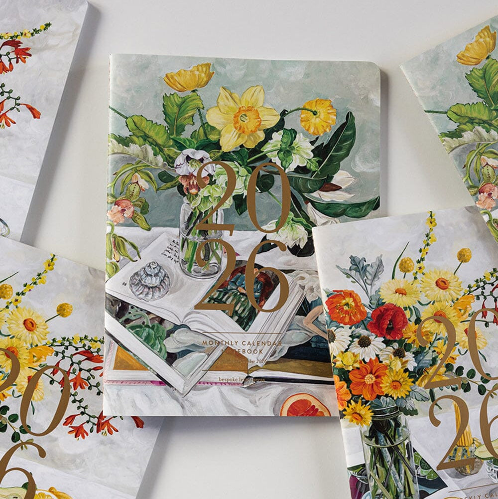 Decorative calendar with floral and vintage design on a white surface