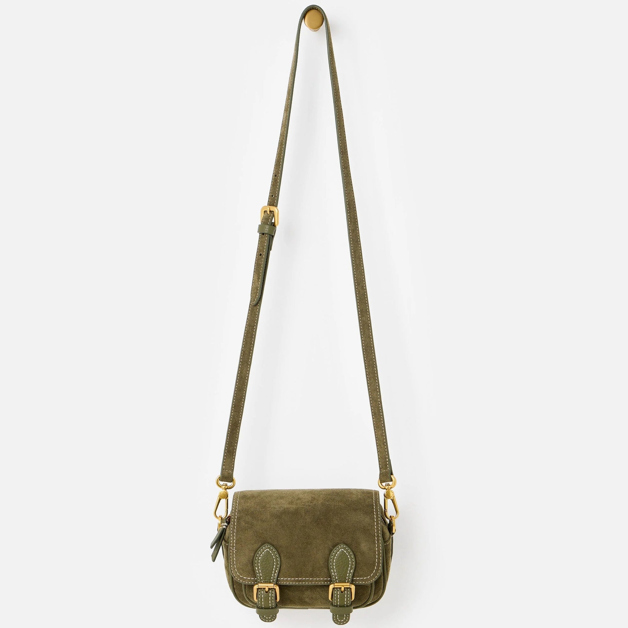 An olive green crossbody satchel bag with a long shoulder strap and gold-tone hardware, shown against a light gray background.