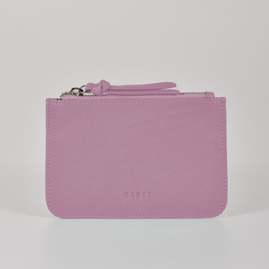 Pink wallet with a strap on a light gray background