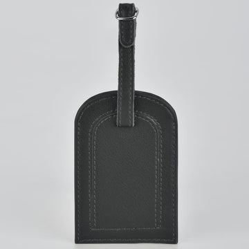 Black leather luggage tag on a light gray background