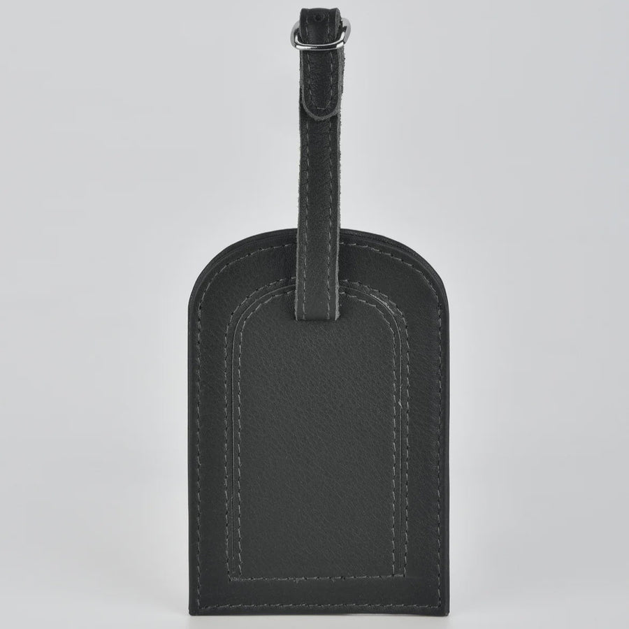 Black leather luggage tag on a light gray background