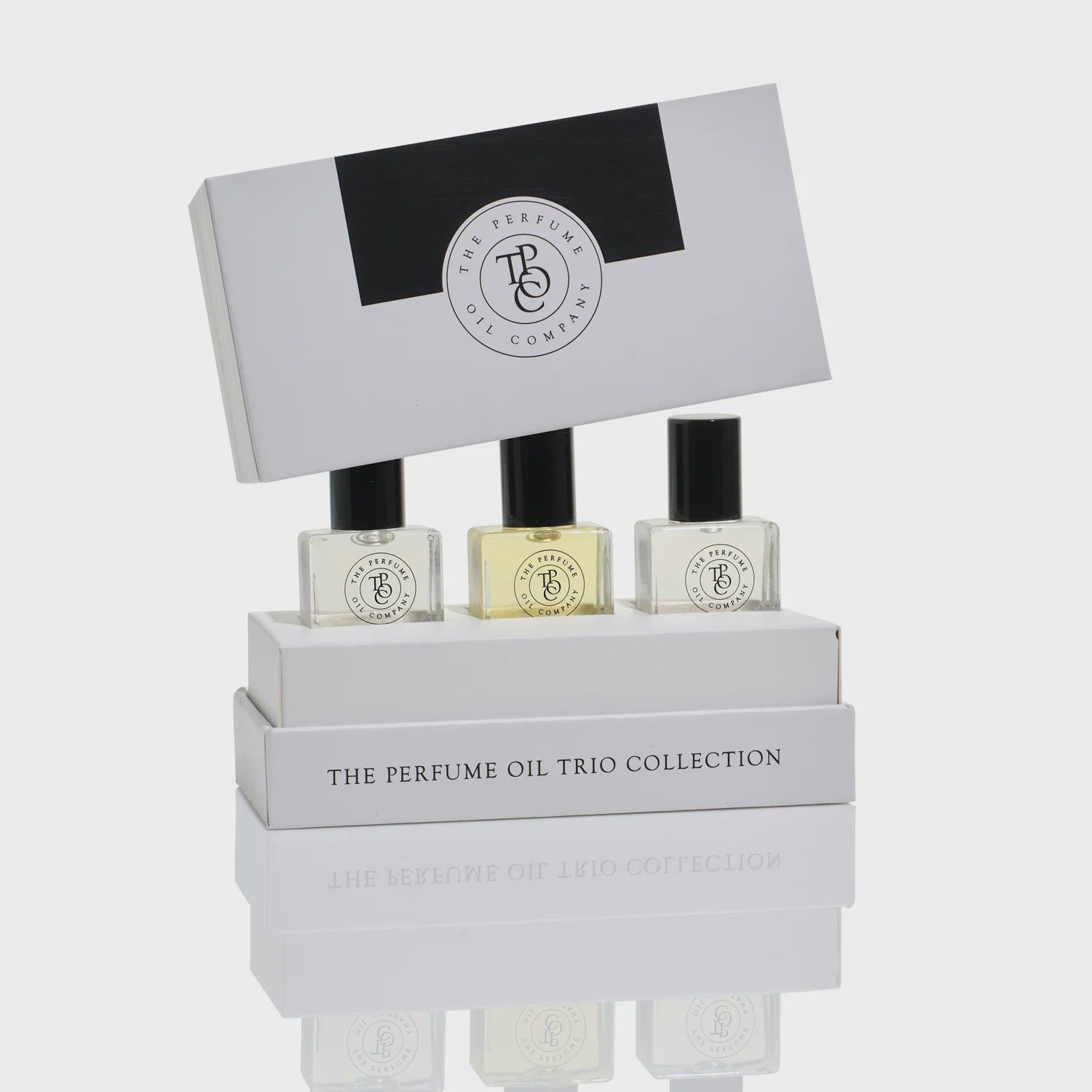 Perfume oil trio collection with a branded box on a white background
