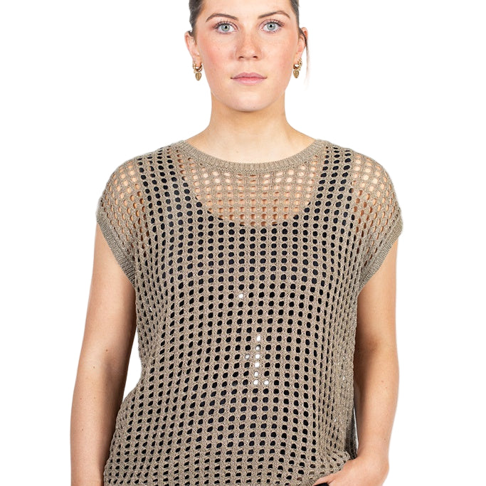 Woman wearing a beige mesh top against a white background
