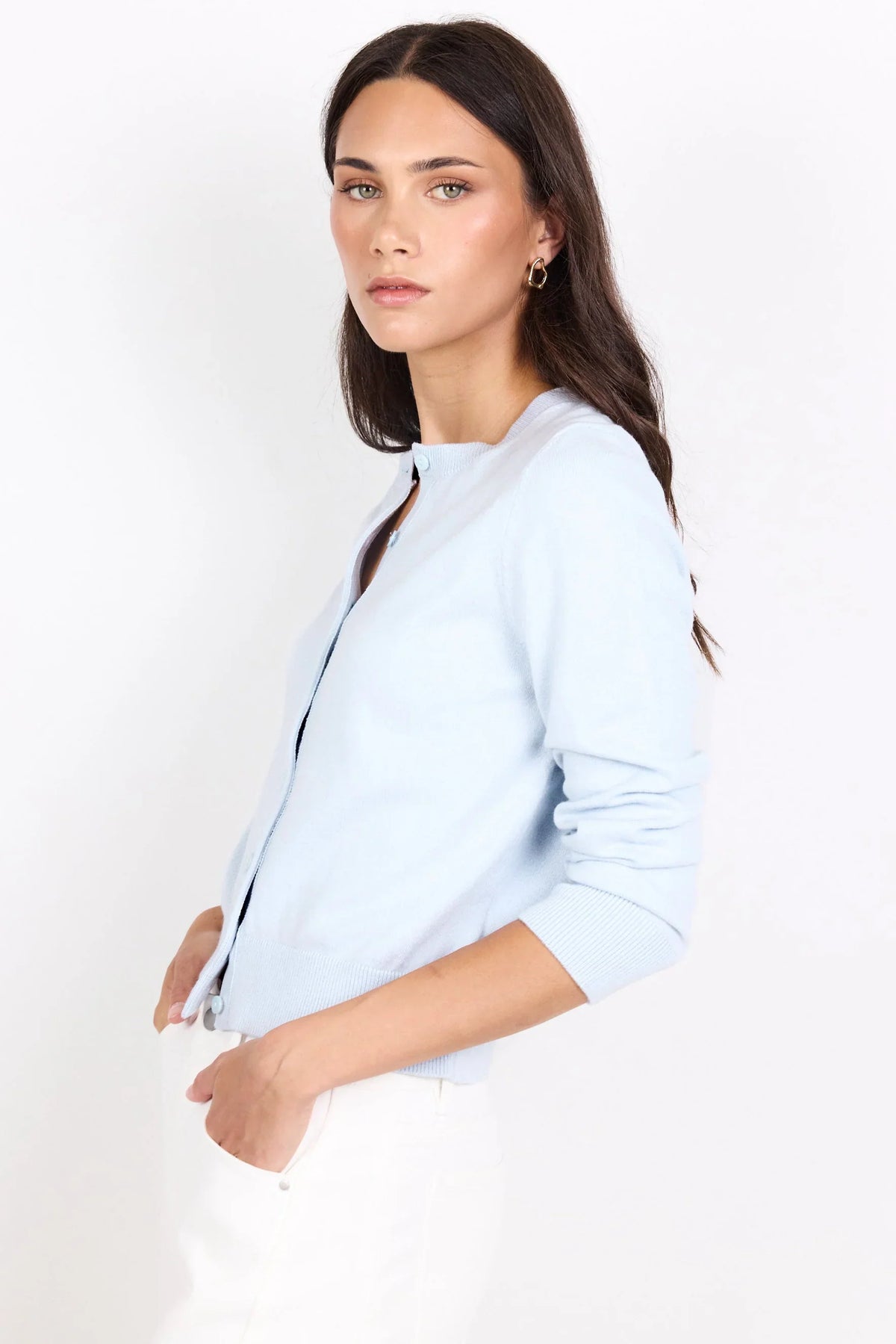 Woman wearing a light blue jacket on a white background