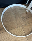 White metal ring on a wooden floor