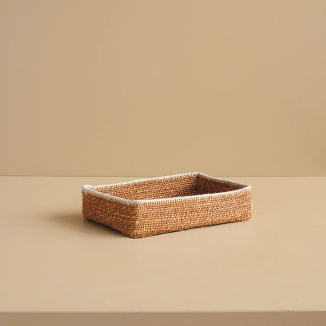 Woven rectangular basket on a beige background