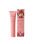 Botanical hand cream with floral packaging on a pink background