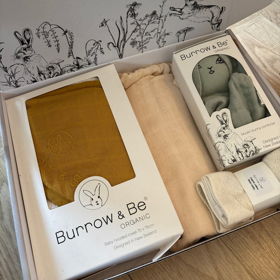 Burrow & Be organic products in packaging on a wooden surface