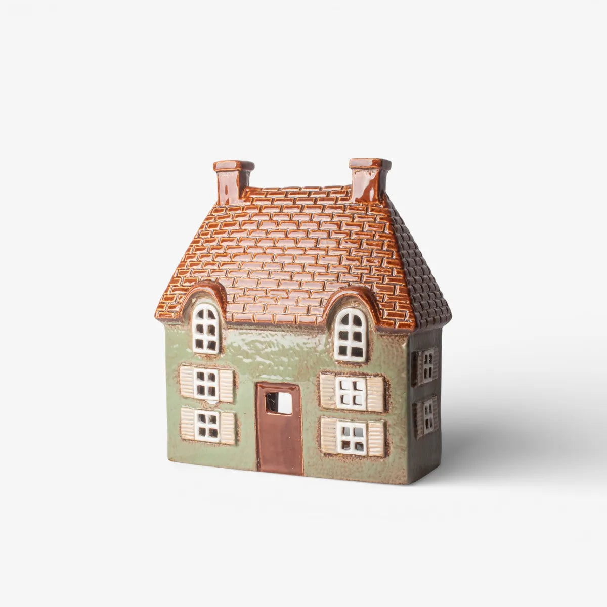 Small model of a house with a tiled roof on a white background