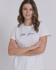 Woman wearing a white t-shirt with text on a plain background