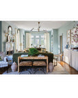Living room with green sofa, wooden coffee table, and decorative elements.