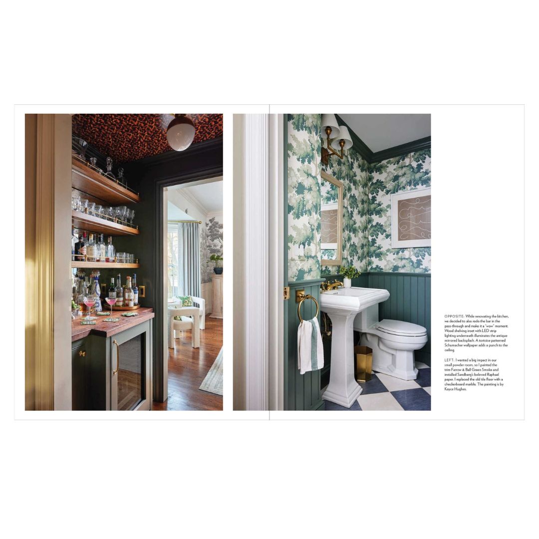 Bathroom interior with green floral wallpaper and white pedestal sink.