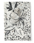 Decorative blanket with floral and leopard print patterns on a white background